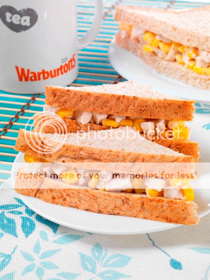 A slice of cake on a plate, with Sandwich and Warburtons