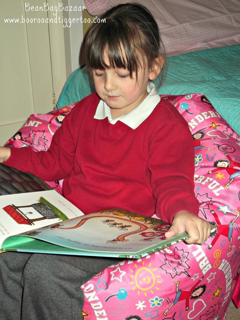 A little girl sitting on a bed