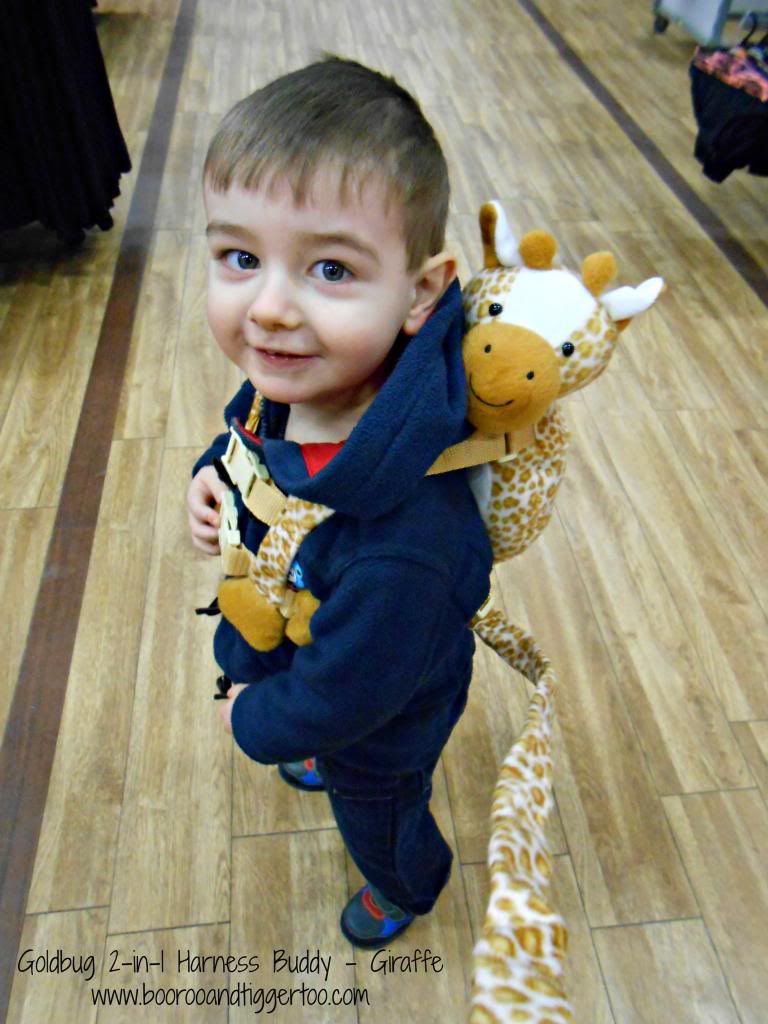 A small child sitting on a wooden floor