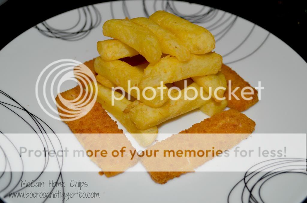A plate of food with a slice cut out, with Fish finger and French fries